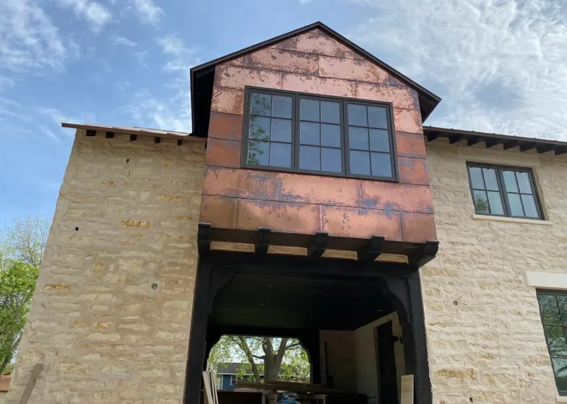 Copper metal panel facade on a stone building for Skylight Installation in Anaconda-Deer Lodge County